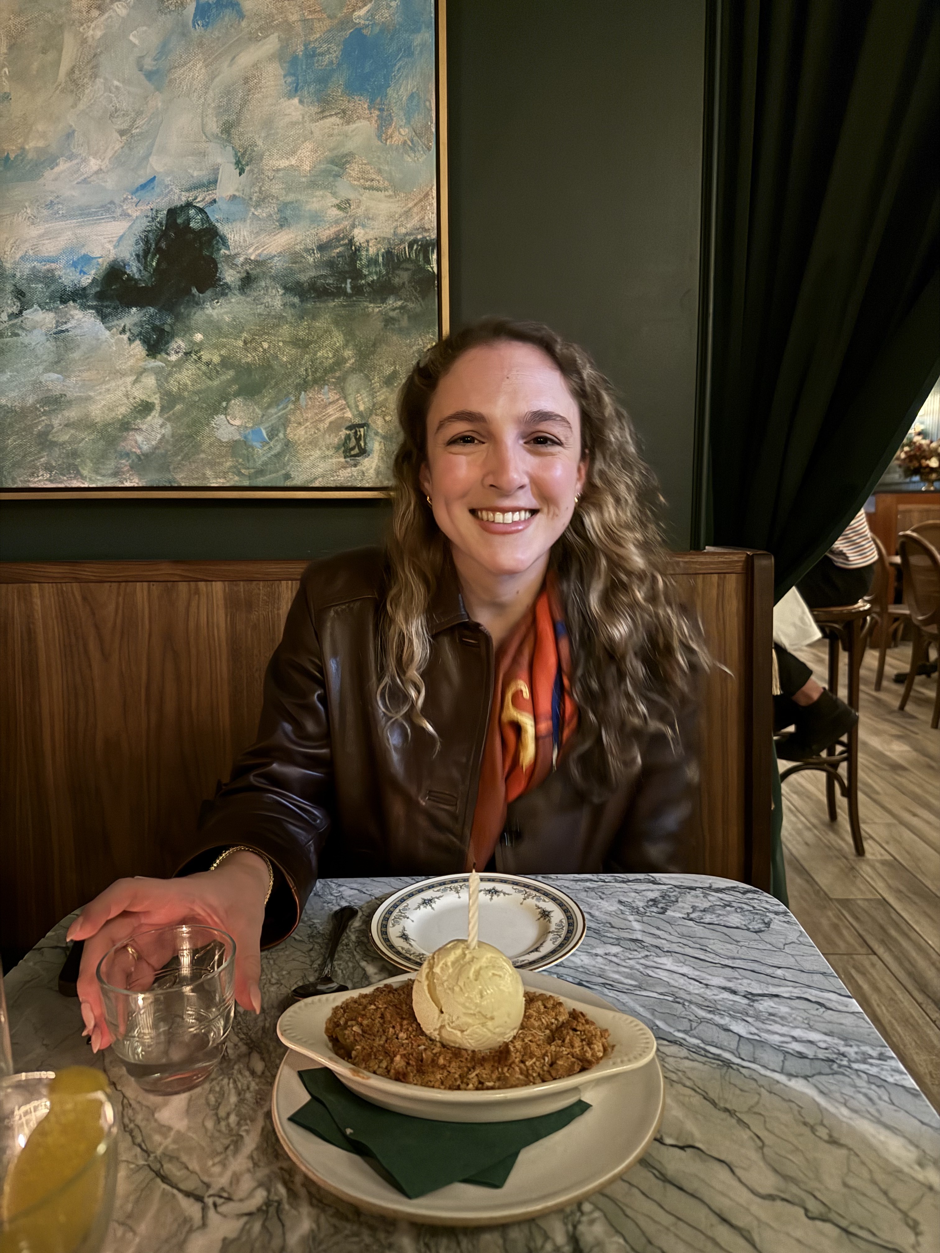 Lelia smiling over dessert